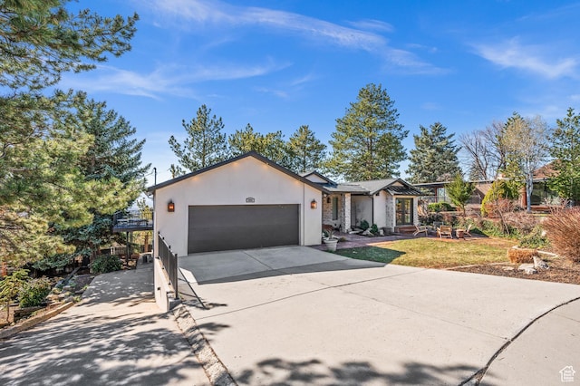 2651 E Hiawatha Cir, Salt Lake City, UT 84108 - view of front facade featuring stucco siding, a garage, and concrete driveway