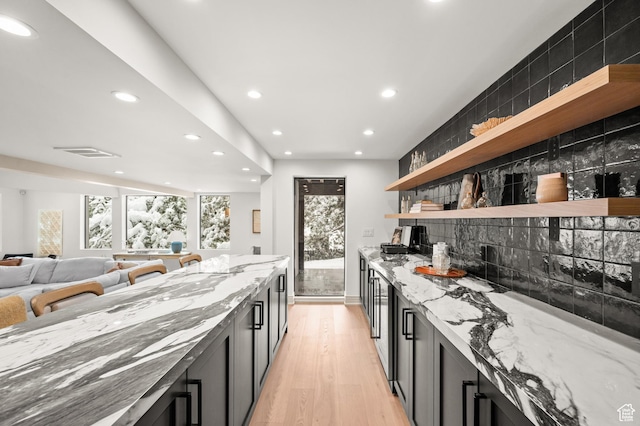 2651 E Hiawatha Cir, Salt Lake City, UT 84108 - kitchen with open shelves, decorative backsplash, light stone counters, and light wood-style floors
