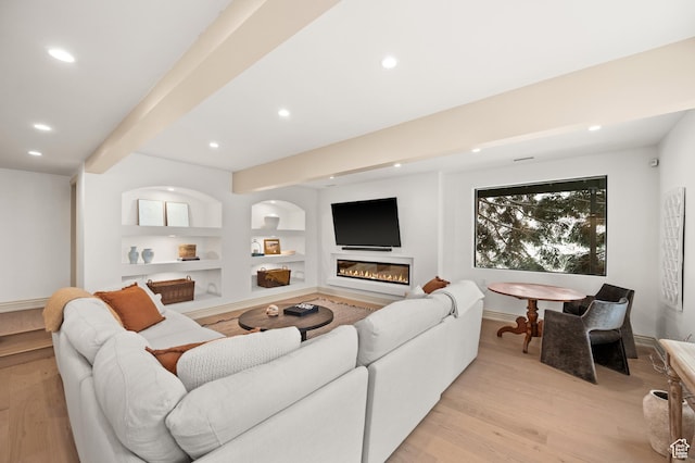 2651 E Hiawatha Cir, Salt Lake City, UT 84108 - living room featuring recessed lighting, beam ceiling, light wood-style floors, and a glass covered fireplace