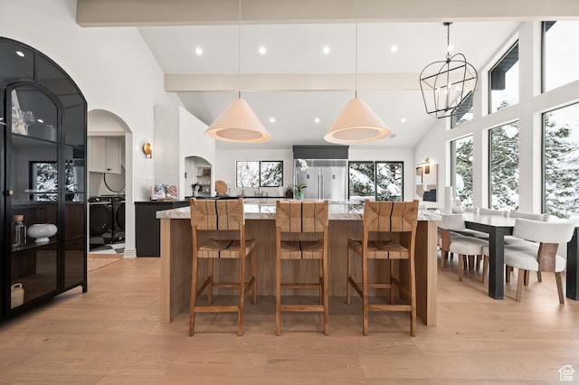 2651 E Hiawatha Cir, Salt Lake City, UT 84108 - interior space featuring light wood finished floors, high vaulted ceiling, beam ceiling, arched walkways, and a chandelier
