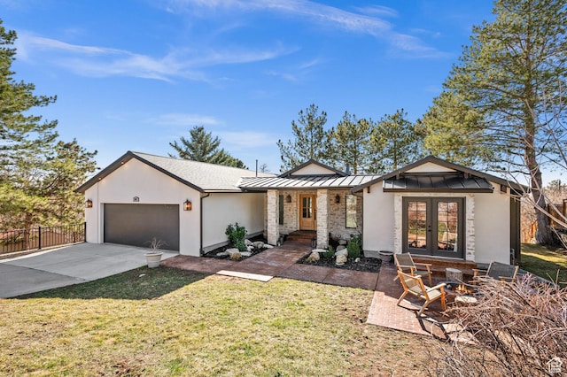 2651 E Hiawatha Cir, Salt Lake City, UT 84108 - view of front of house featuring fence, a standing seam roof, an attached garage, concrete driveway, and french doors