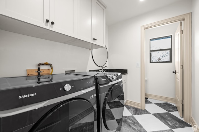 2651 E Hiawatha Cir, Salt Lake City, UT 84108 - laundry room with baseboards, washing machine and dryer, tile patterned floors, cabinet space, and a sink