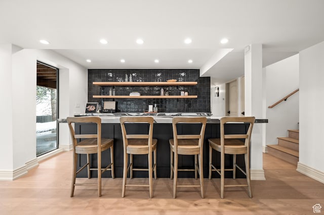 2651 E Hiawatha Cir, Salt Lake City, UT 84108 - bar featuring stairs, decorative backsplash, recessed lighting, light wood-style flooring, and wet bar