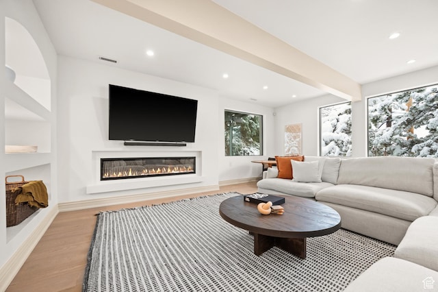 2651 E Hiawatha Cir, Salt Lake City, UT 84108 - living room featuring visible vents, beamed ceiling, a glass covered fireplace, recessed lighting, and light wood-style floors