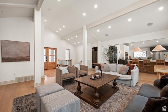 2651 E Hiawatha Cir, Salt Lake City, UT 84108 - living area featuring light wood-type flooring, visible vents, arched walkways, and high vaulted ceiling
