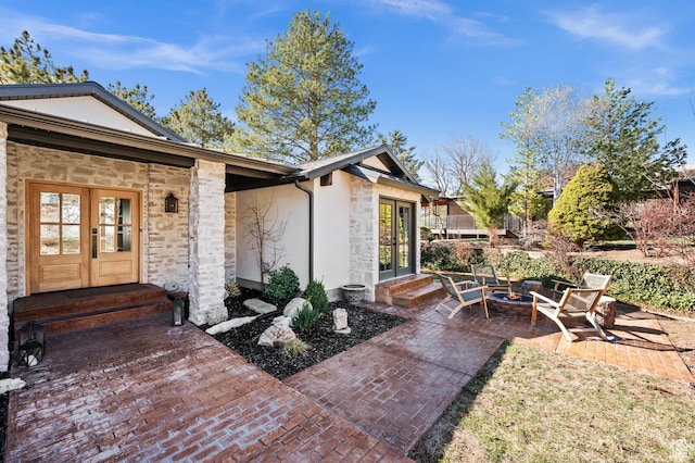 2651 E Hiawatha Cir, Salt Lake City, UT 84108 - doorway to property featuring a patio area, stone siding, stucco siding, and french doors
