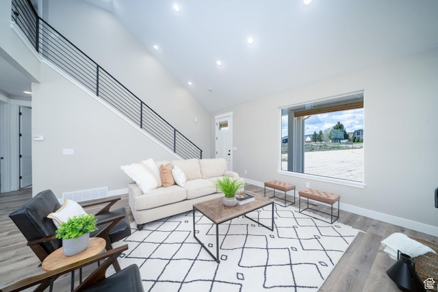 2678 S Eagle Dr Unit 12, Garden City, UT 84028 - living room with stairs, wood finished floors, high vaulted ceiling, visible vents, and recessed lighting