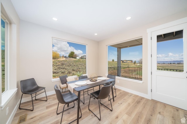 2678 S Eagle Dr Unit 12, Garden City, UT 84028 - dining room featuring baseboards, light wood-type flooring, and a healthy amount of sunlight