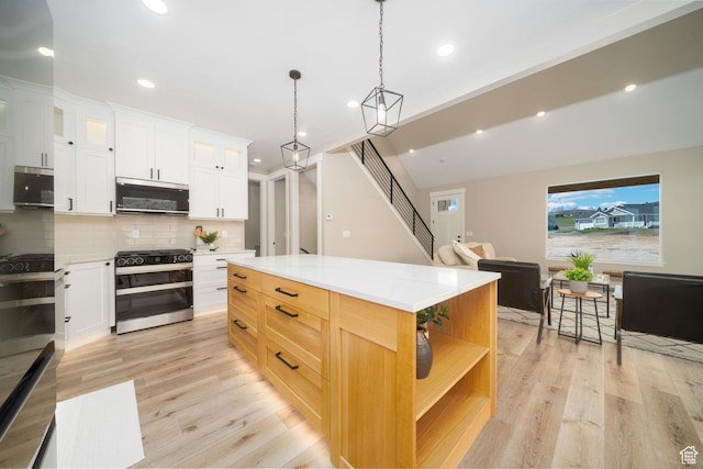 2678 S Eagle Dr Unit 12, Garden City, UT 84028 - kitchen featuring light wood-style flooring, open shelves, decorative backsplash, and appliances with stainless steel finishes
