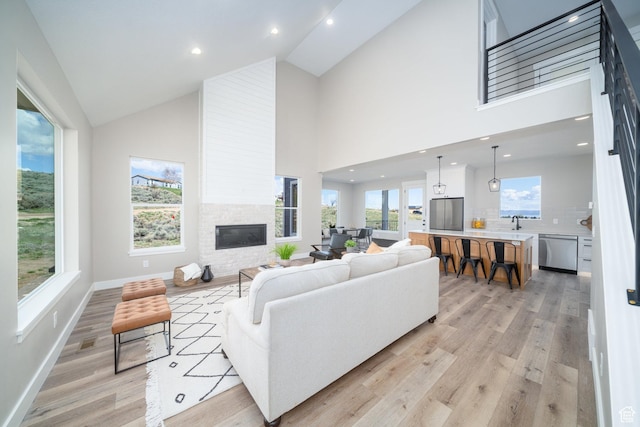 2678 S Eagle Dr Unit 12, Garden City, UT 84028 - living room featuring light wood-type flooring, a fireplace, baseboards, and recessed lighting
