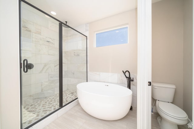 2678 S Eagle Dr Unit 12, Garden City, UT 84028 - full bathroom with tile walls, toilet, a shower stall, and a freestanding tub