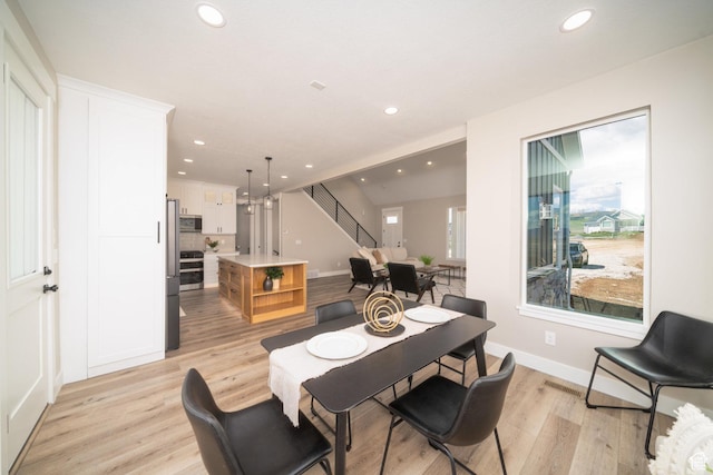 2678 S Eagle Dr Unit 12, Garden City, UT 84028 - dining space with recessed lighting, light wood-style floors, baseboards, and stairs