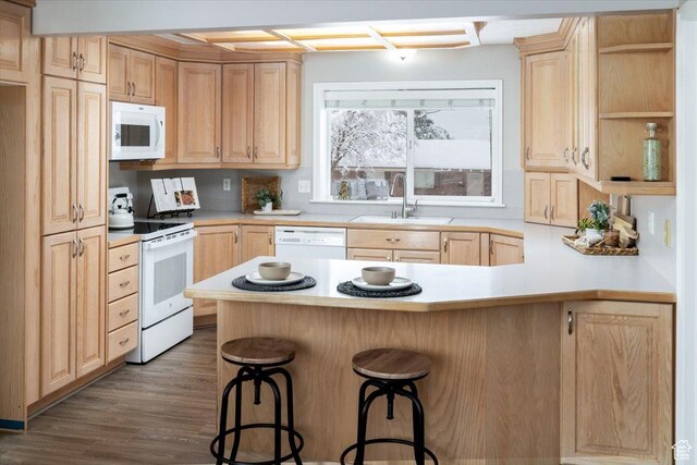 kitchen with white appliances, light brown cabinets, open shelves, a peninsula, and a sink