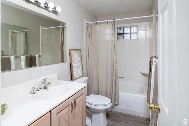 bathroom featuring vanity, wood finished floors, shower / bath combo, a textured ceiling, and toilet