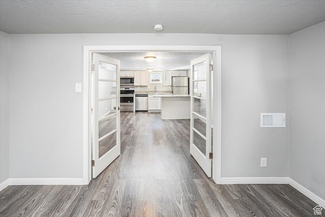 hallway with baseboards and dark wood-style floors