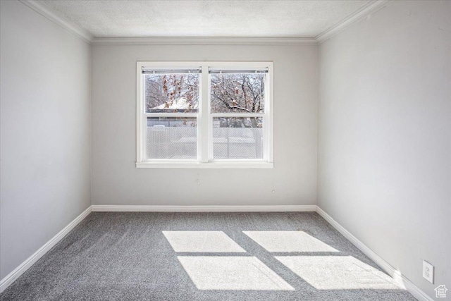carpeted spare room featuring ornamental molding, baseboards, and a textured ceiling