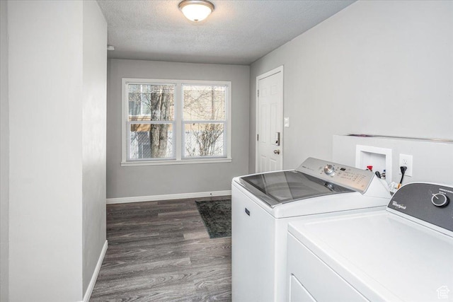 laundry room featuring baseboards, washing machine and clothes dryer, laundry area, dark wood-type flooring, and a textured ceiling
