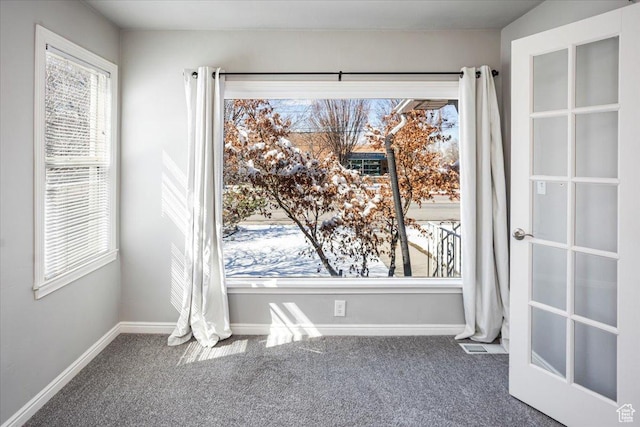 carpeted spare room with baseboards