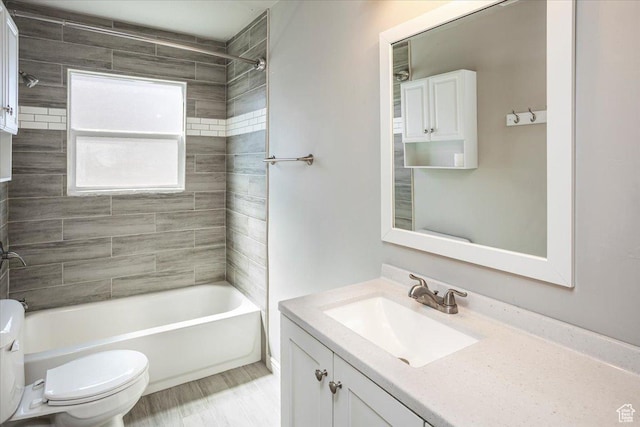full bath featuring tub / shower combination, toilet, and vanity