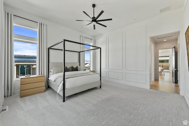 4784 W Juniper Bend Cir, Herriman, UT 84096 - bedroom with a decorative wall, a ceiling fan, visible vents, and light carpet