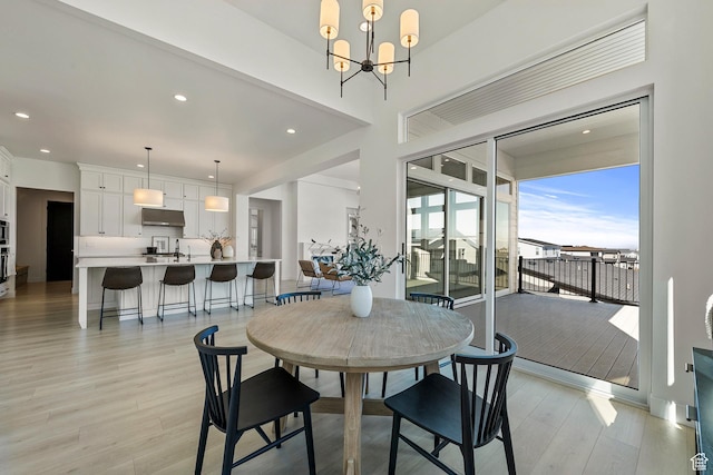 4784 W Juniper Bend Cir, Herriman, UT 84096 - dining space with a chandelier, recessed lighting, and light wood-style floors