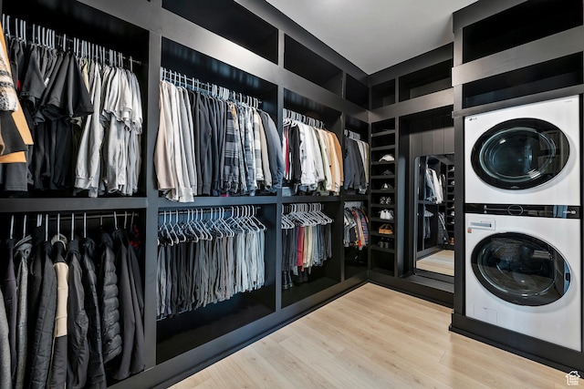4784 W Juniper Bend Cir, Herriman, UT 84096 - walk in closet featuring stacked washer and dryer and wood finished floors