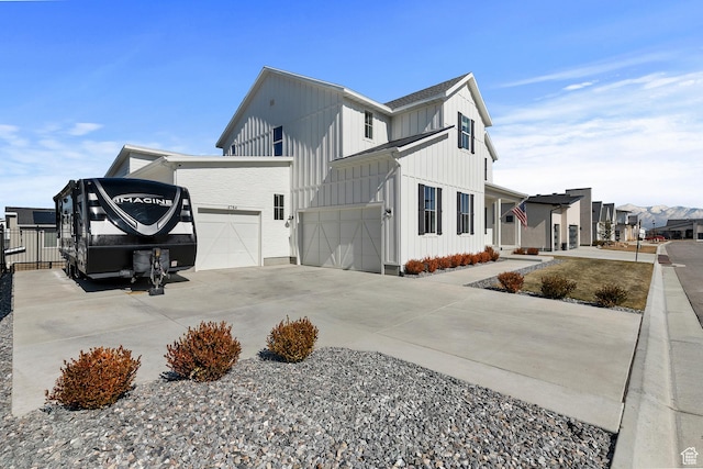 4784 W Juniper Bend Cir, Herriman, UT 84096 - view of side of home with board and batten siding, an attached garage, and driveway