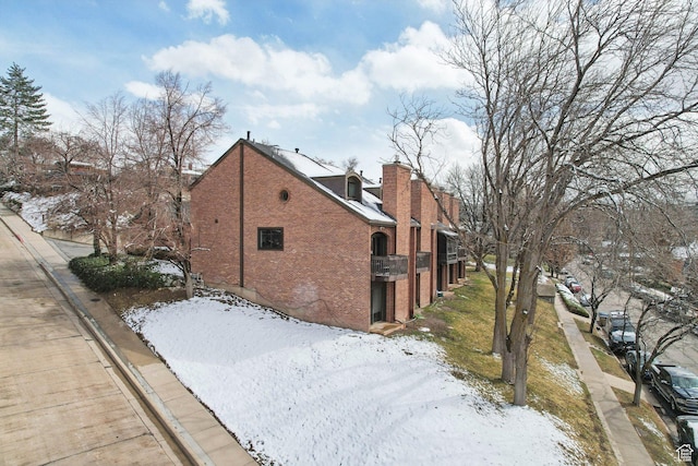 71 W Apricot Ave, Salt Lake City, UT 84103 - snow covered property featuring brick siding and a chimney