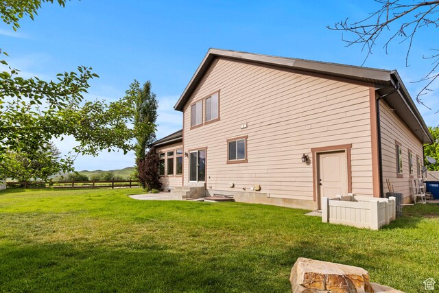5927 Dartmouth Dr, Mountain Green, UT 84050 - back of house featuring a lawn and a patio