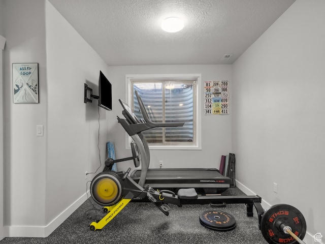 5927 Dartmouth Dr, Mountain Green, UT 84050 - exercise room featuring a textured ceiling and baseboards