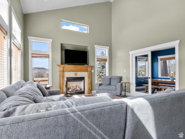 5927 Dartmouth Dr, Mountain Green, UT 84050 - living room featuring high vaulted ceiling, a fireplace, and baseboards