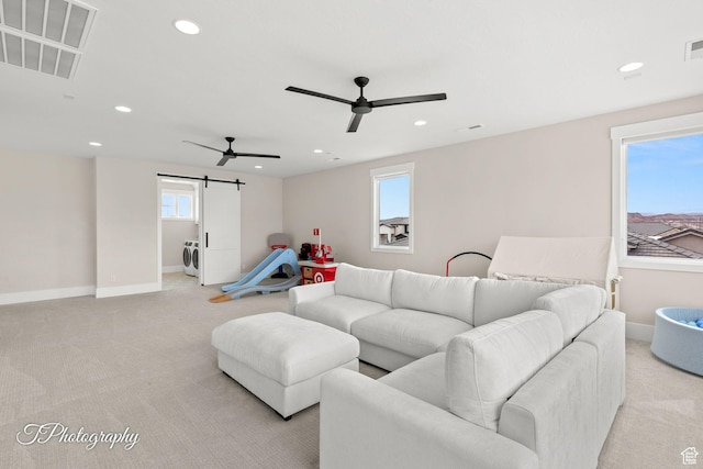 2092 S 3010 E, St George, UT 84790 - living room with visible vents, light carpet, washer / clothes dryer, a barn door, and ceiling fan