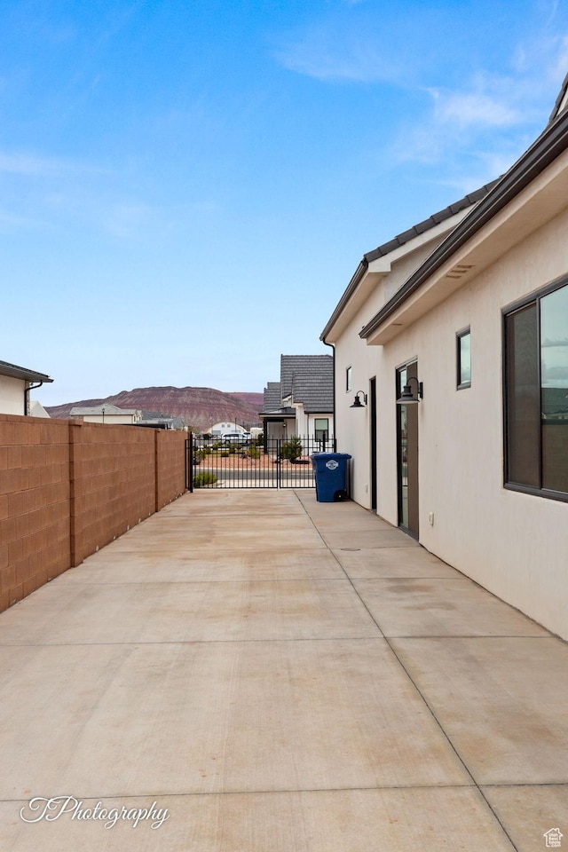 2092 S 3010 E, St George, UT 84790 - view of patio with a gate, a mountain view, and fence