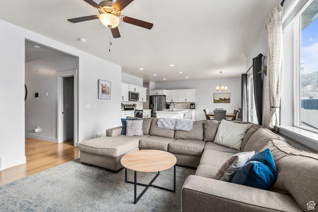 373 S 850 E, American Fork, UT 84003 - living area featuring recessed lighting, ceiling fan with notable chandelier, light wood-style floors, and baseboards