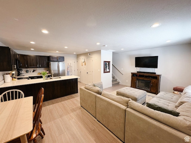 1788 N 1280 E, Payson, UT 84651 - living area with light wood finished floors, stairway, recessed lighting, a glass covered fireplace, and a textured ceiling