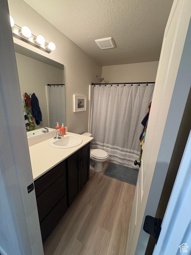 1788 N 1280 E, Payson, UT 84651 - full bathroom with visible vents, toilet, vanity, wood finished floors, and a textured ceiling