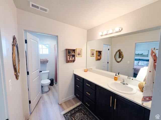 1788 N 1280 E, Payson, UT 84651 - ensuite bathroom with vanity, wood finished floors, visible vents, a textured ceiling, and toilet