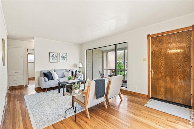 living area with light wood finished floors and baseboards