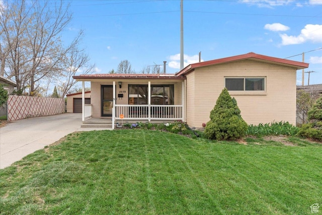 view of front of home featuring covered porch, a front lawn, and brick siding