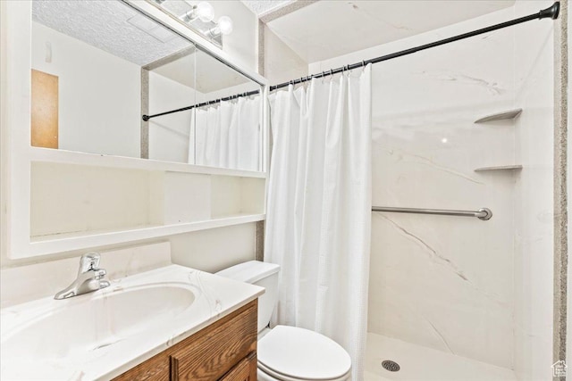 bathroom with vanity, toilet, and a shower stall