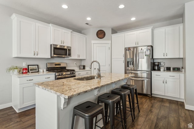 280 S 675 W, Centerville, UT 84014 - kitchen with appliances with stainless steel finishes, recessed lighting, a breakfast bar, dark wood finished floors, and white cabinets