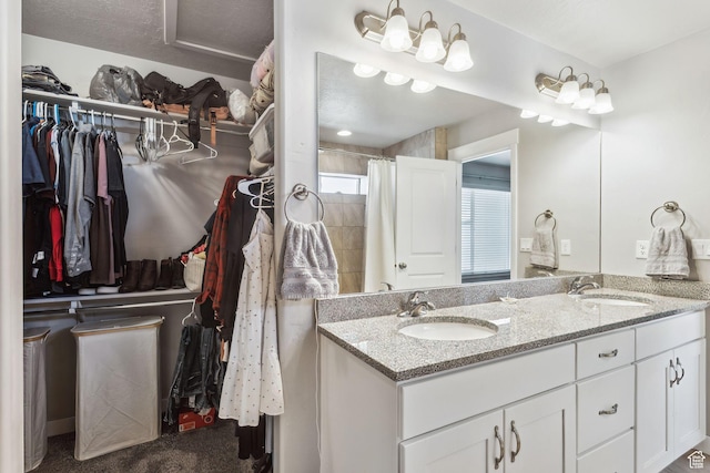 280 S 675 W, Centerville, UT 84014 - bathroom featuring double vanity, a spacious closet, and curtained shower
