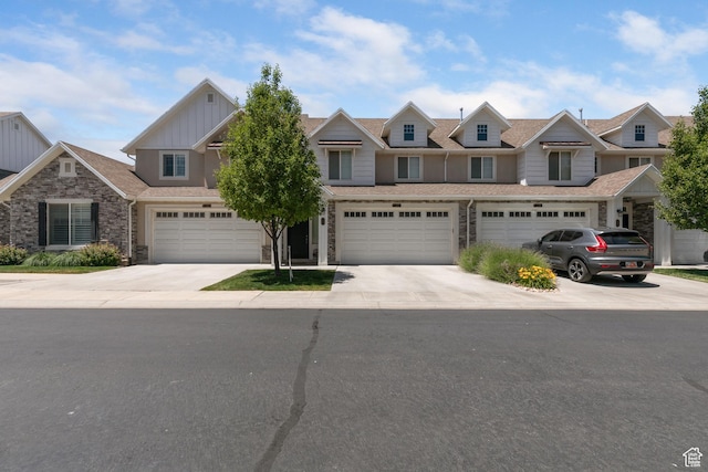 280 S 675 W, Centerville, UT 84014 - view of property featuring board and batten siding, driveway, stone siding, and an attached garage