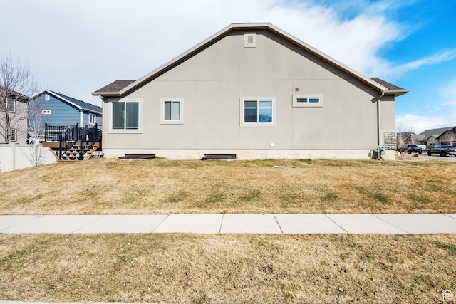 view of home's exterior with a lawn and a wooden deck