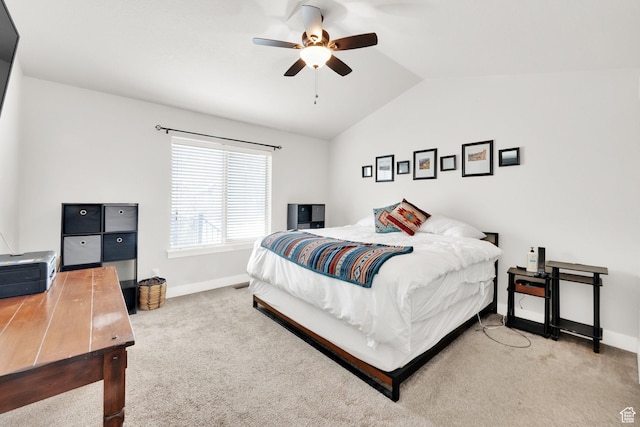bedroom featuring lofted ceiling, carpet, baseboards, and ceiling fan