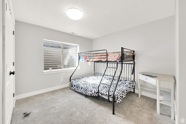 carpeted bedroom with visible vents and baseboards