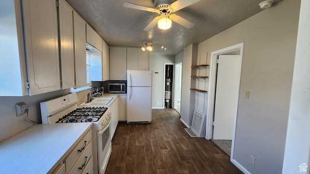 1330 N 800 W, Provo, UT 84604 - kitchen with light countertops, dark wood-style floors, white appliances, a textured ceiling, and a sink