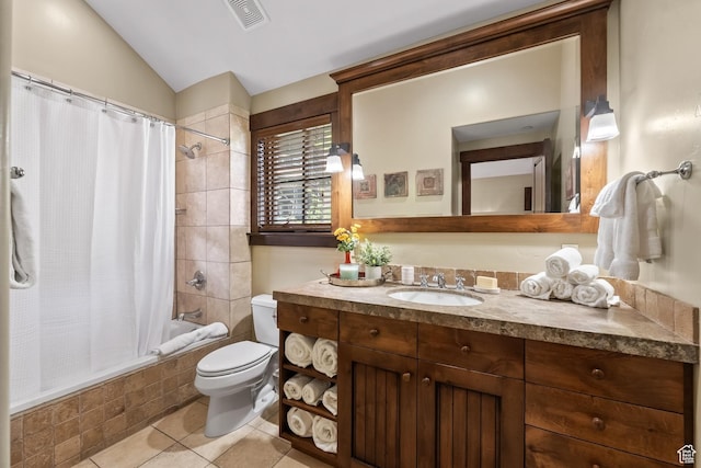 full bathroom featuring tile patterned flooring, visible vents, toilet, vaulted ceiling, and tiled shower / bath combo