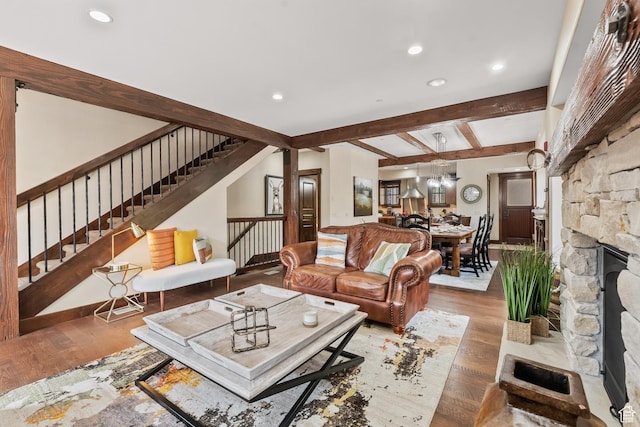 living room with beam ceiling, stairway, recessed lighting, and light wood finished floors