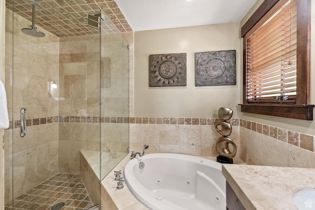 bathroom featuring vanity, a shower stall, and a jetted tub